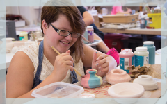 student painting pottery